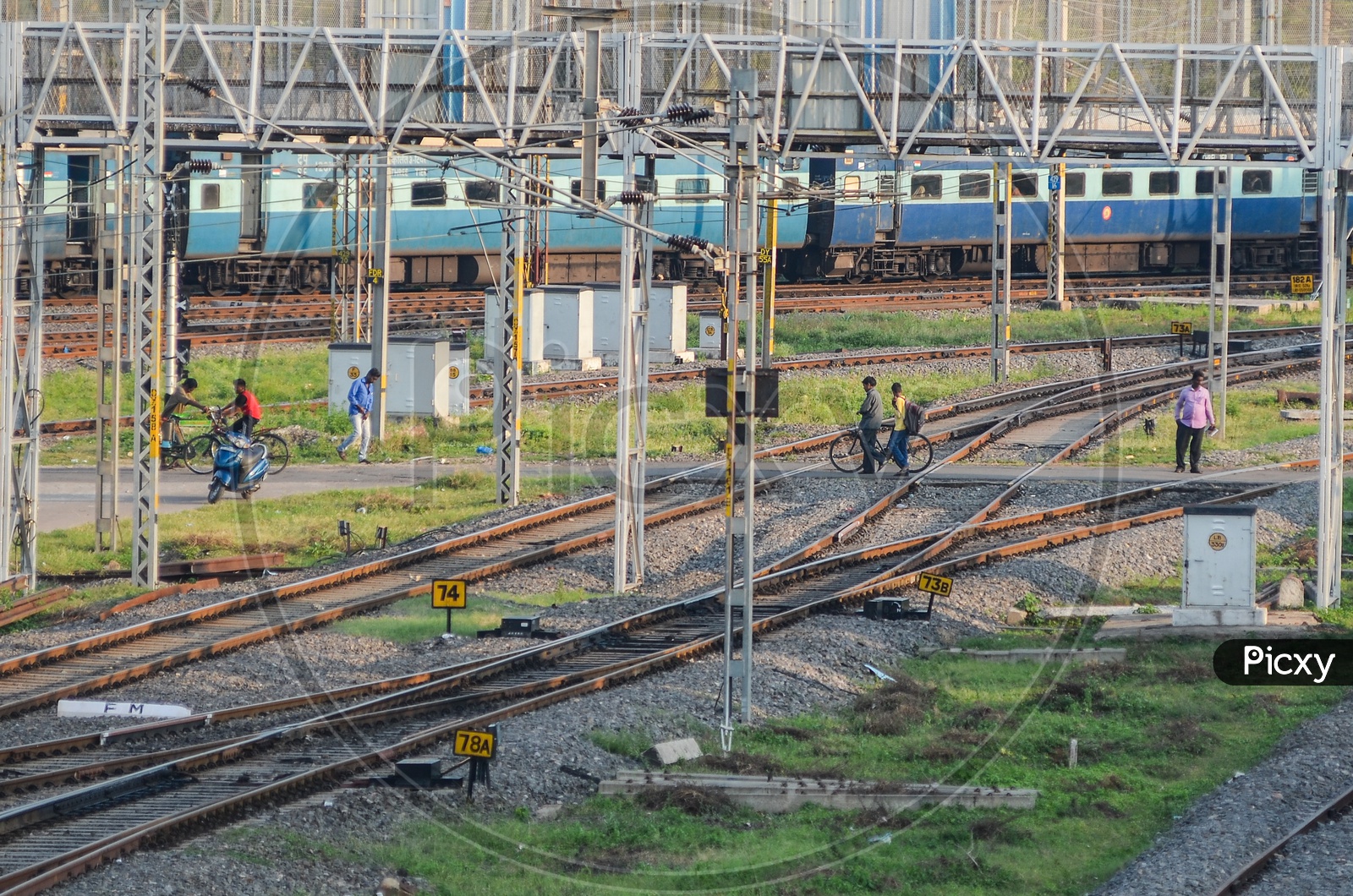 People cross railway tracks