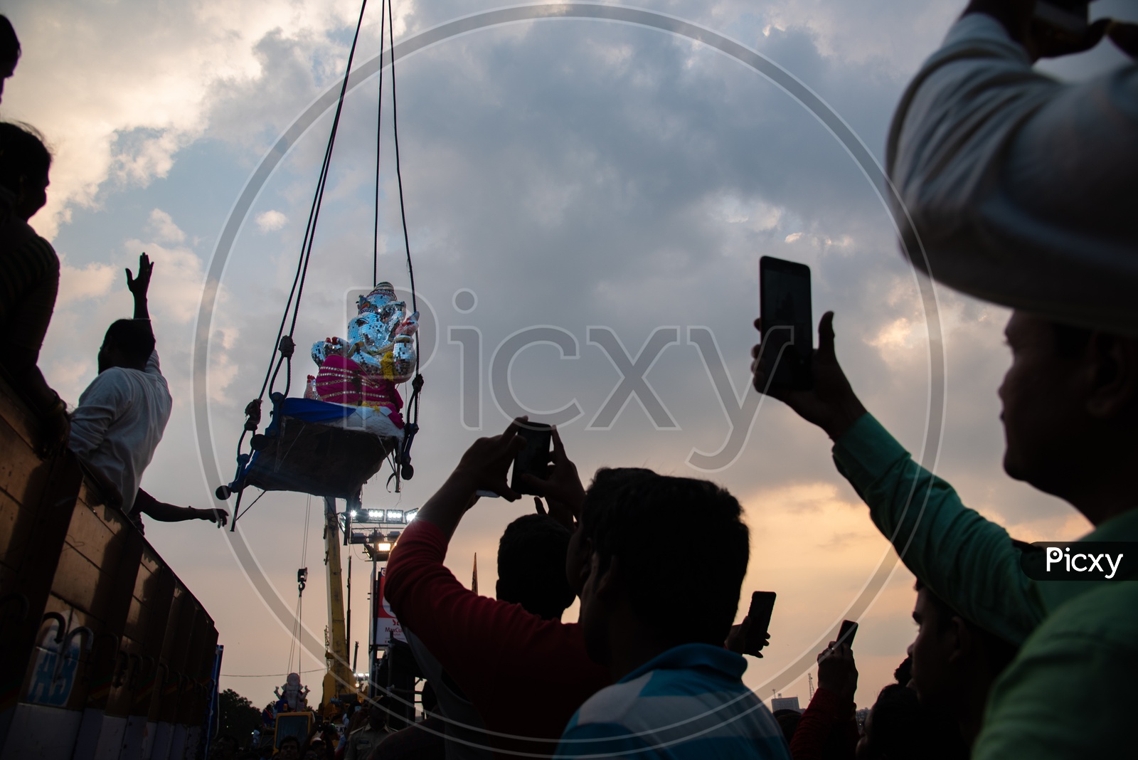 People trying to capture glimpses of their diety, Ganesh before immersion in their Smart Mobile Phones