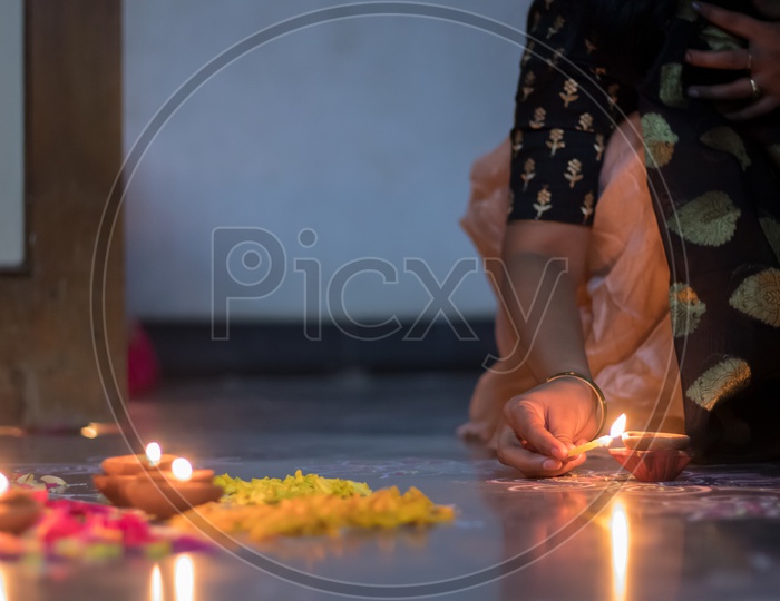 Indian Hindu Festival Diwali Dias Lighting Up by  women  Closeup Shot