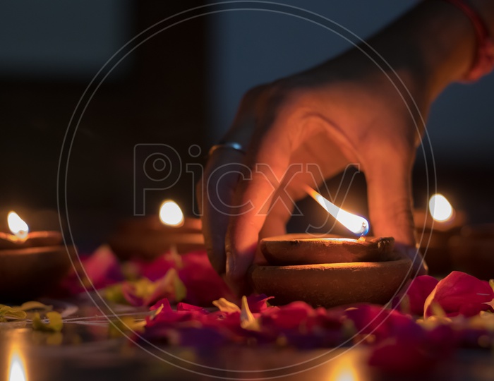 Indian Hindu Festival Diwali Dias Lighting Up by  women  Closeup Shot