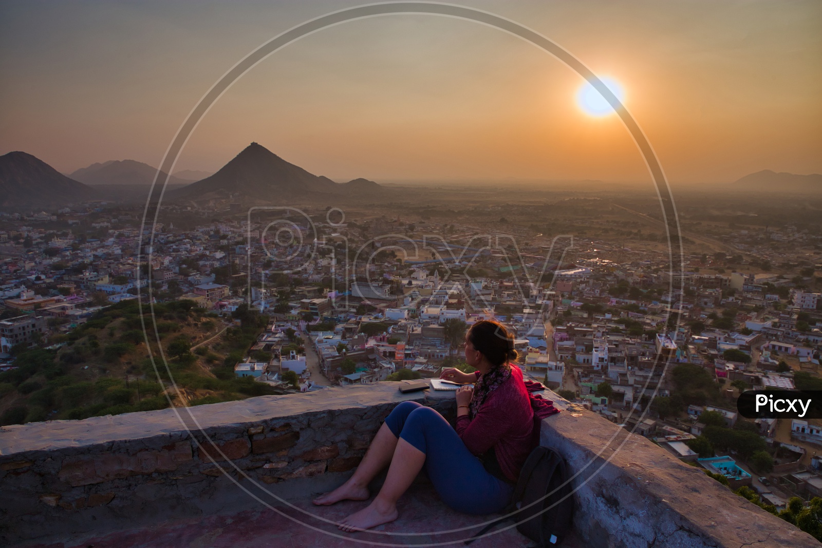 A Beautiful Sunset Over a City Watching By a Woman
