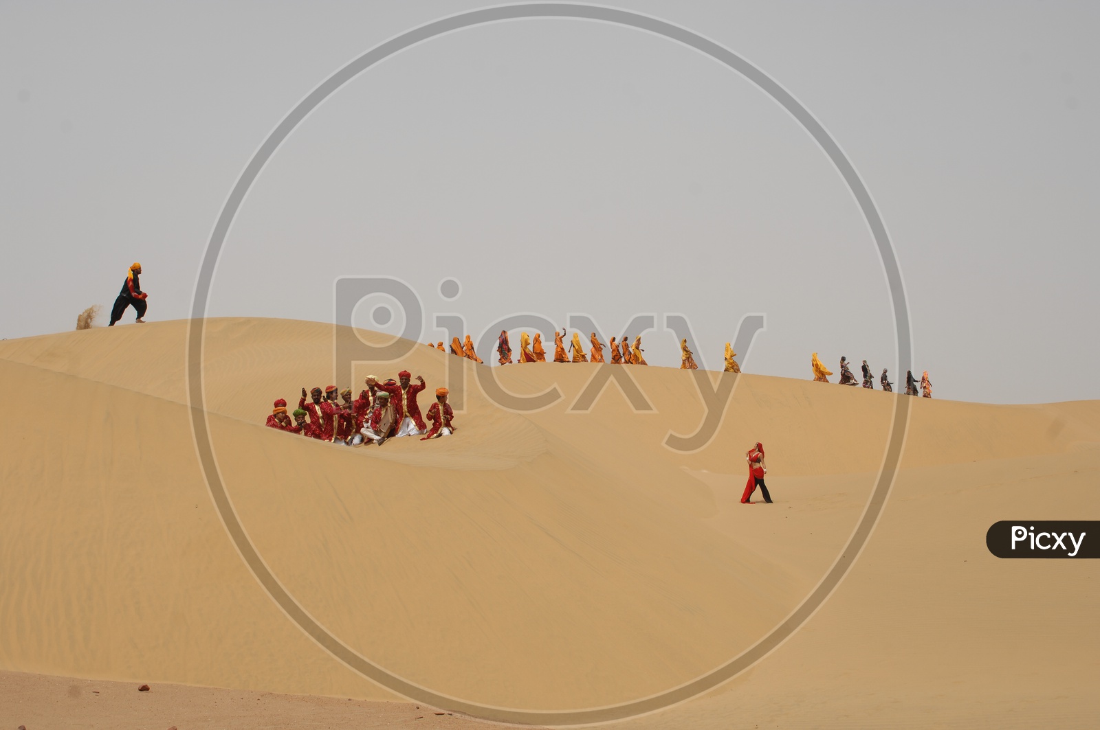 Indian women and men dancing in Rajasthan Desert