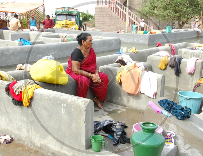 Woman washing clothes at a Dhobi Ghat