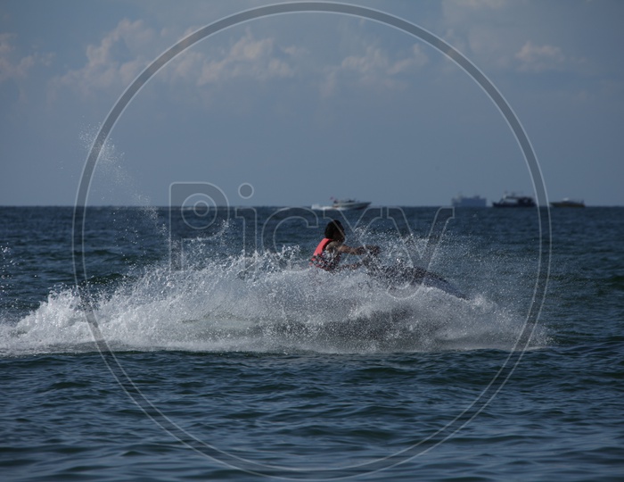 A man surfing with a Speed Boat on the Sea