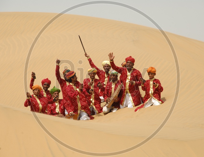 Rajasthani Men dancing and Singing in a desert,India