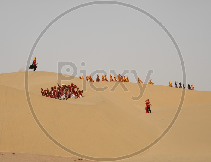 Indian women and men dancing in Rajasthan Desert
