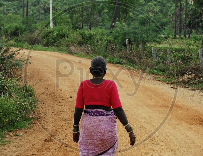 Poor Indian women at rural road