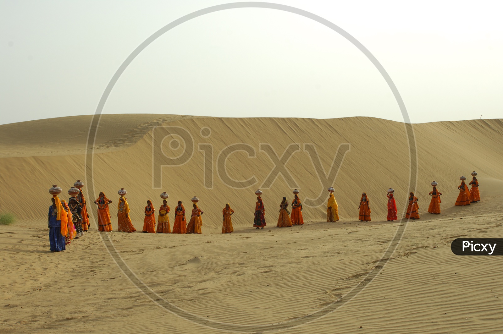 Indian Female with Pots on heads in Rajasthan desert