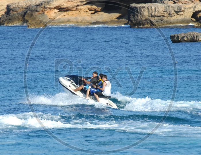 Foreign Men surfing on a Speed boat