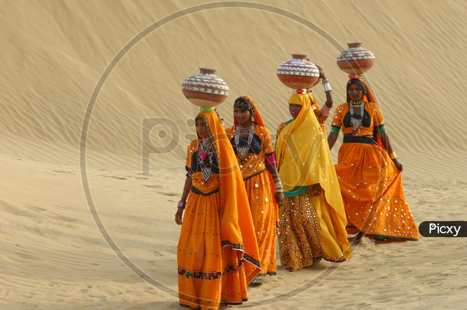 Indian Female with Pots in desert Rajasthan