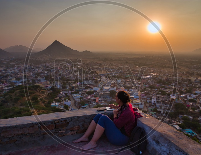 A Beautiful Sunset Over a City Watching By a Woman