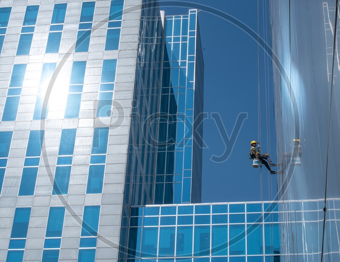 Workers Cleaning the Facade of WaveRock SEZ Building in Hyderabad