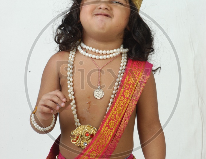 Indian Boy in Lord Sri Krishna Getup   Over an isolated White Background