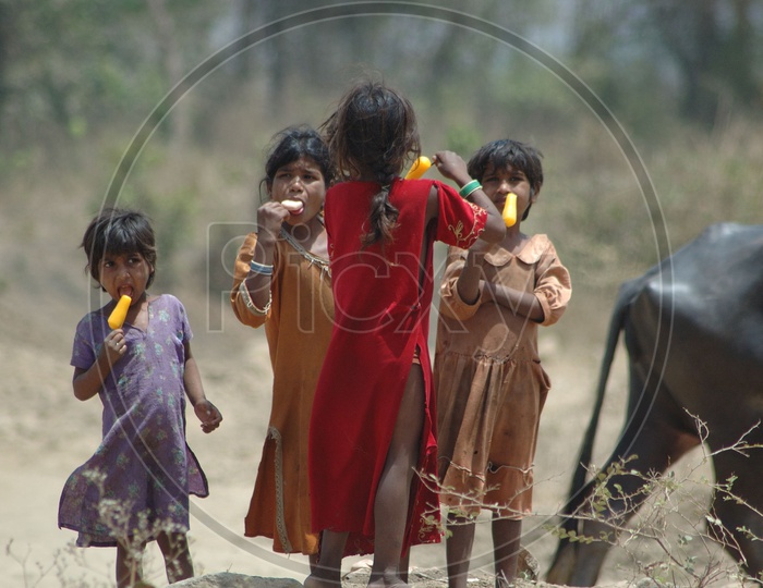 Indian Children In Rural Villages Eating Ice Fruits