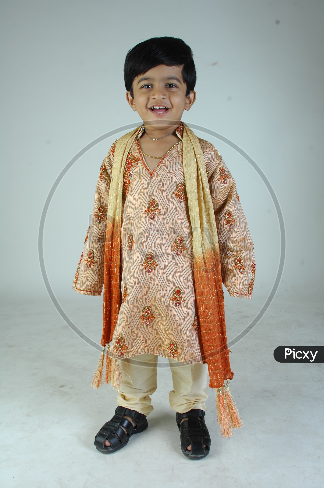 Image of Indian Boy in Traditional Clothes With a Smiling Face Over an