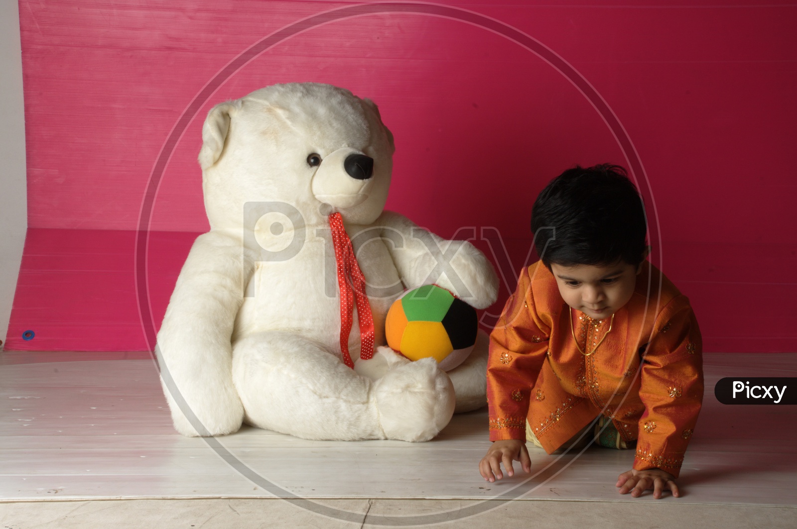 Indian Kid with a white teddy/soft toy