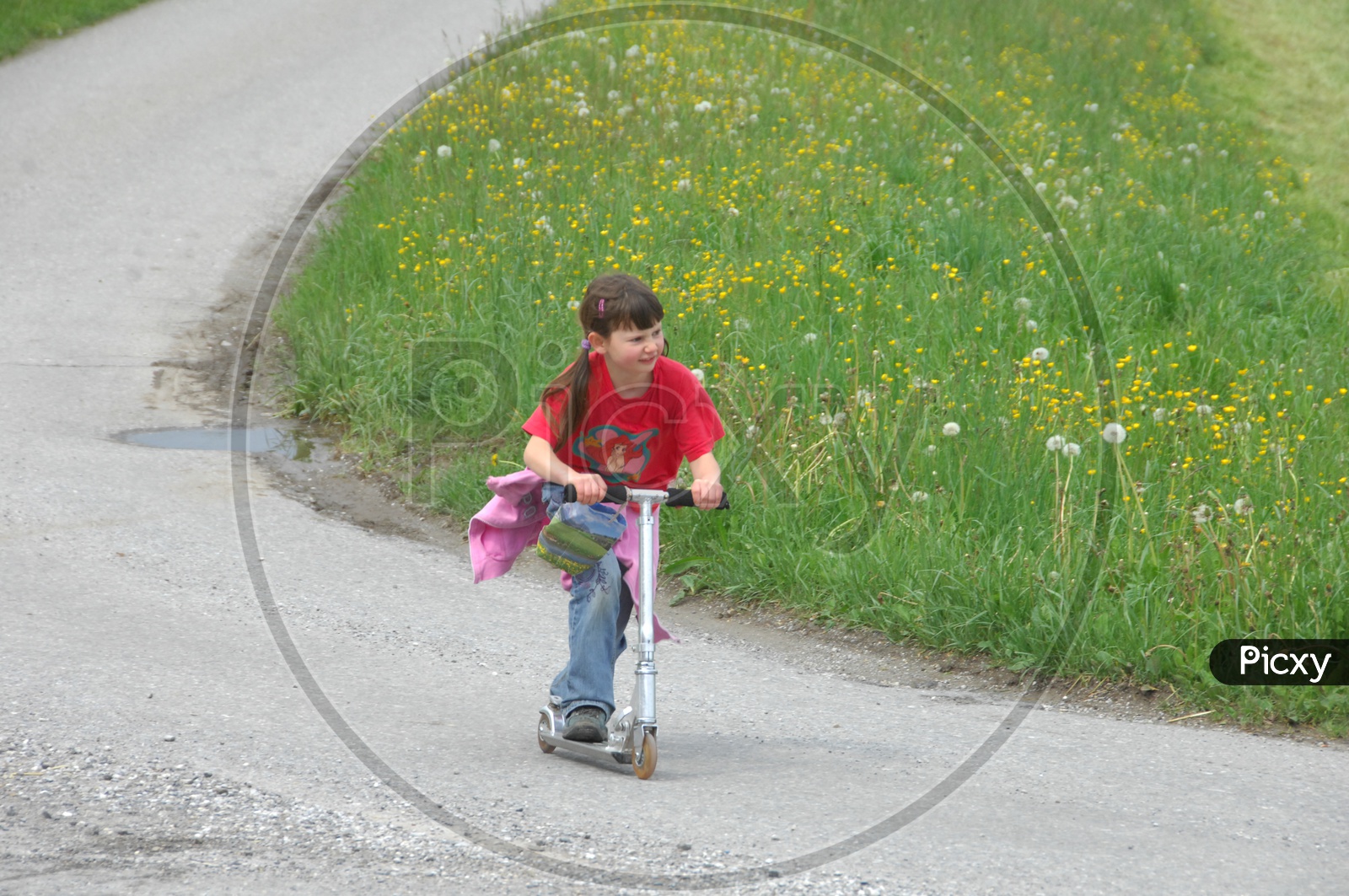 Girl Child Playing With a Skateboard Bike