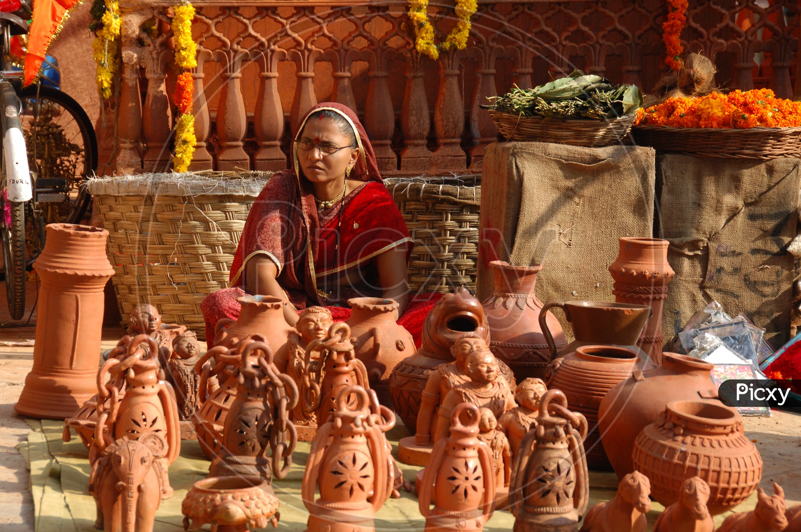 Indian woman clay lantern vendor