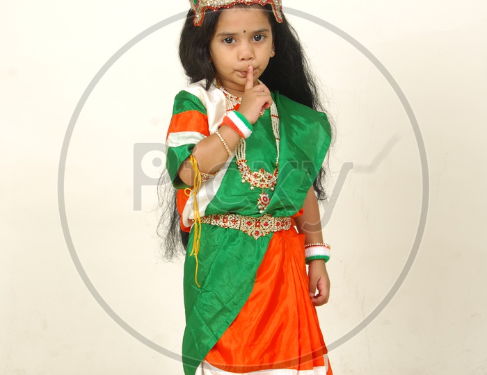 Indian Girl Child in Bharath Maatha Getup and Cute Expressions   over an Isolated White Background