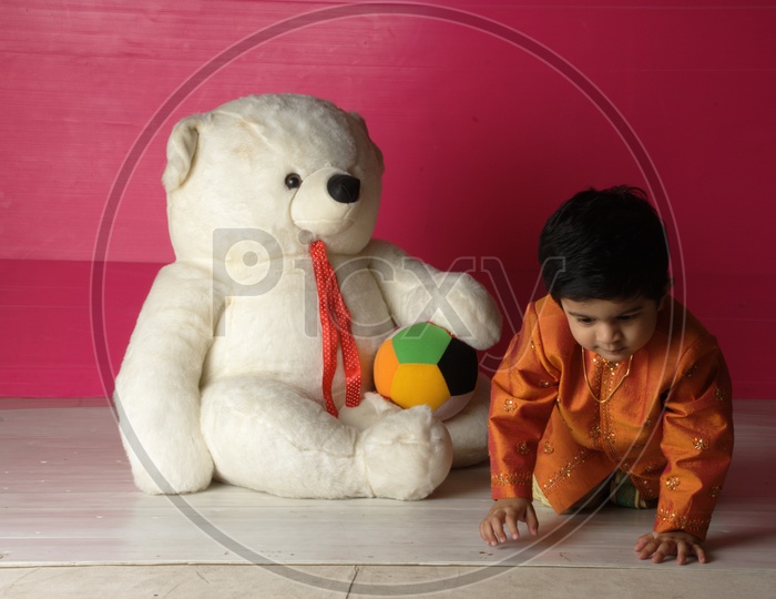 Indian Kid with a white teddy/soft toy