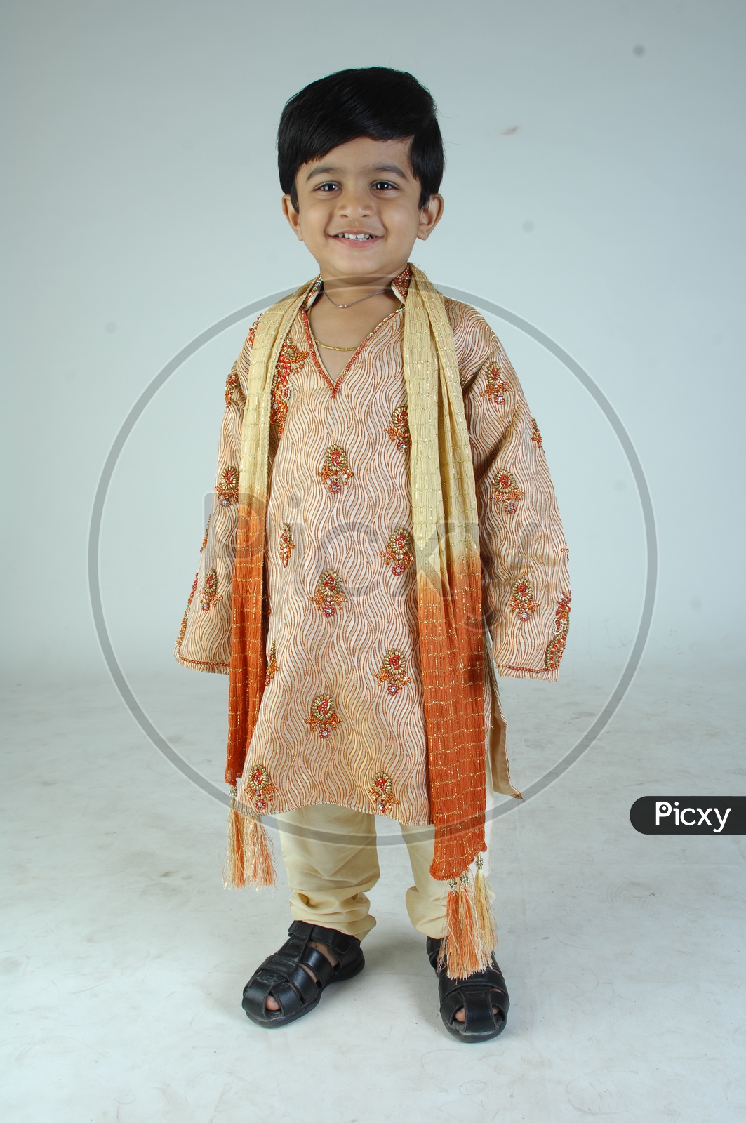 Indian Boy in Traditional Clothes With a Smiling Face Over an Isolated White Background