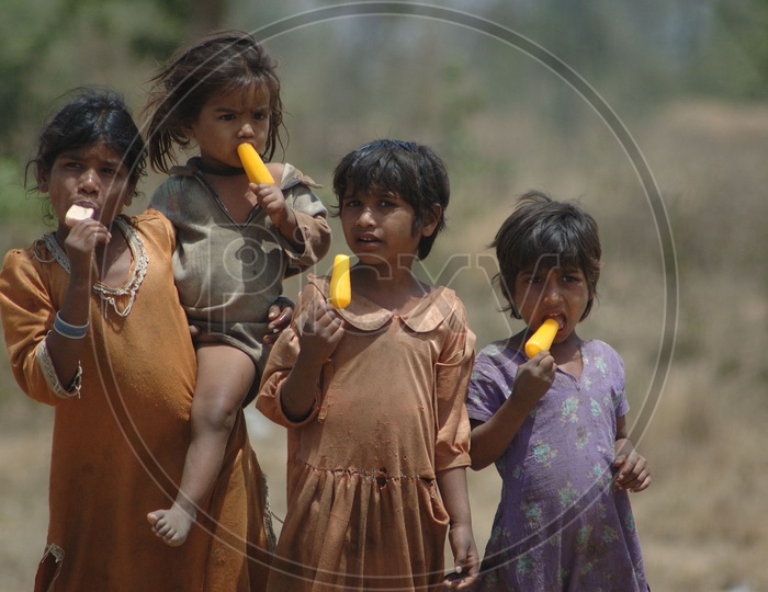 Indian Children In Rural Villages Eating Ice Fruits