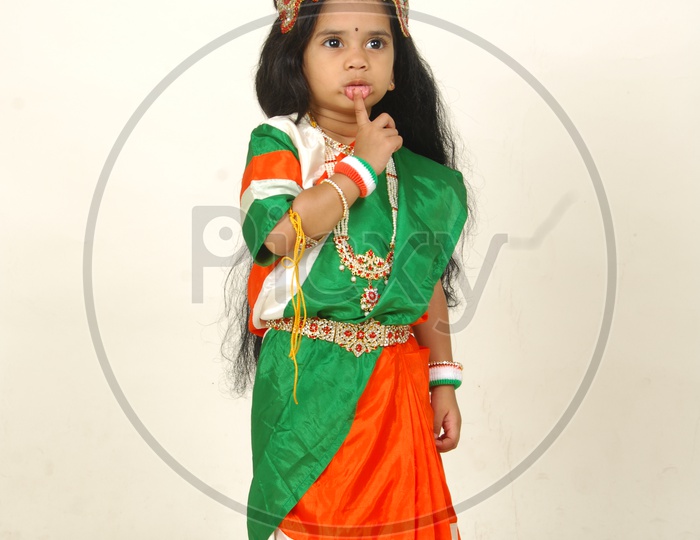 Indian Girl Child in Bharath Maatha Getup and Cute Expressions   over an Isolated White Background