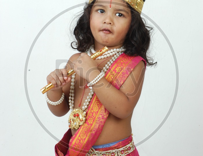Indian Boy in Lord Sri Krishna Getup  Over an isolated White Background