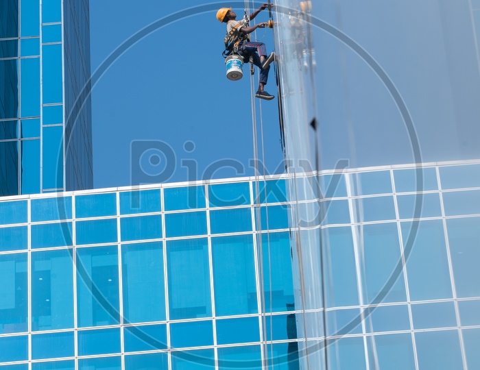 Workers Cleaning the Facade of WaveRock SEZ Building in Hyderabad