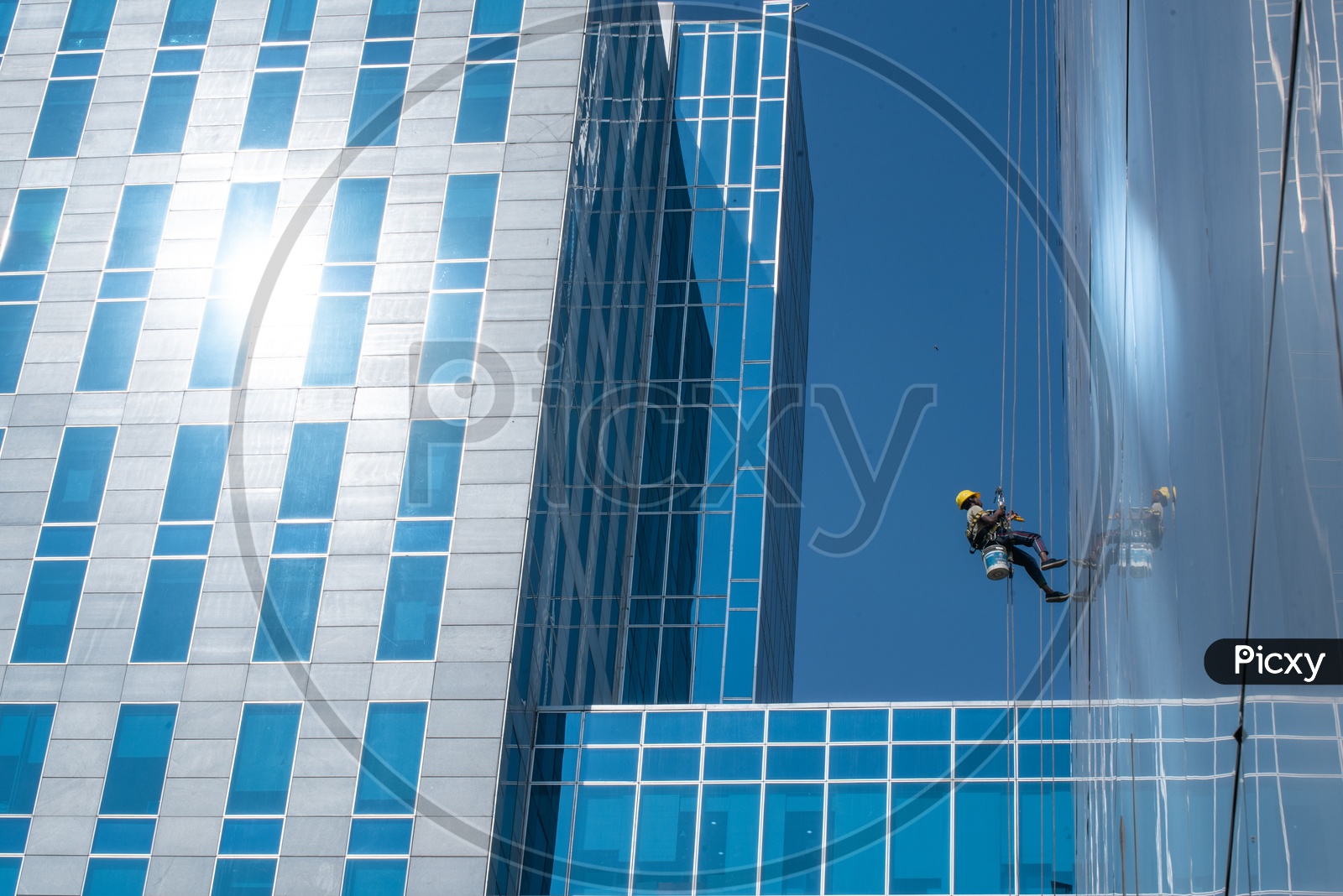 Image of Workers Cleaning the Facade of WaveRock SEZ Building in