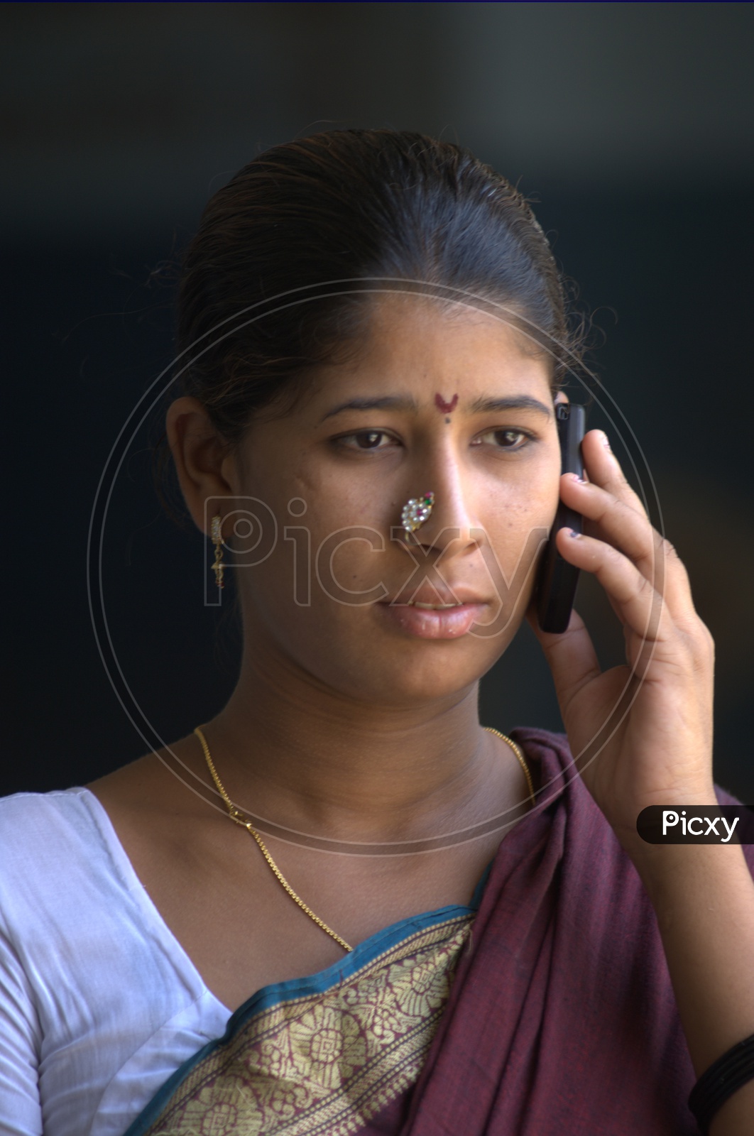 Indian Rural Woman speaking  in Mobile Phone