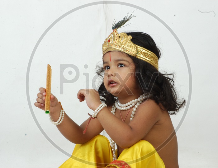 Indian Boy in Lord Sri Krishna Getup Over an isolated White Background