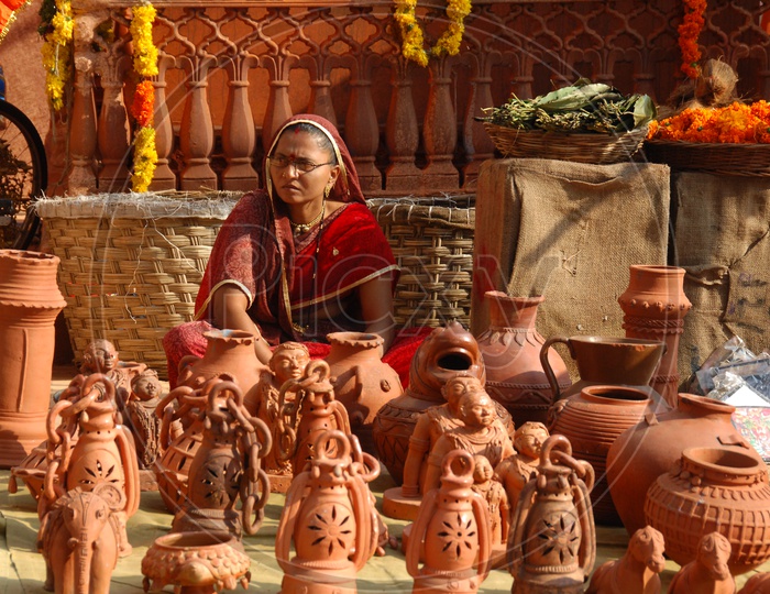 Indian woman clay lantern vendor