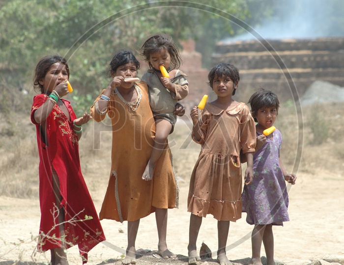 Indian Stray Children Eating Ice Fruits