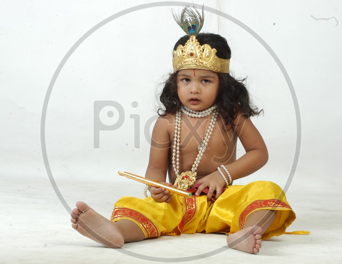 Indian Boy in Lord Sri Krishna Getup Over an isolated White Background