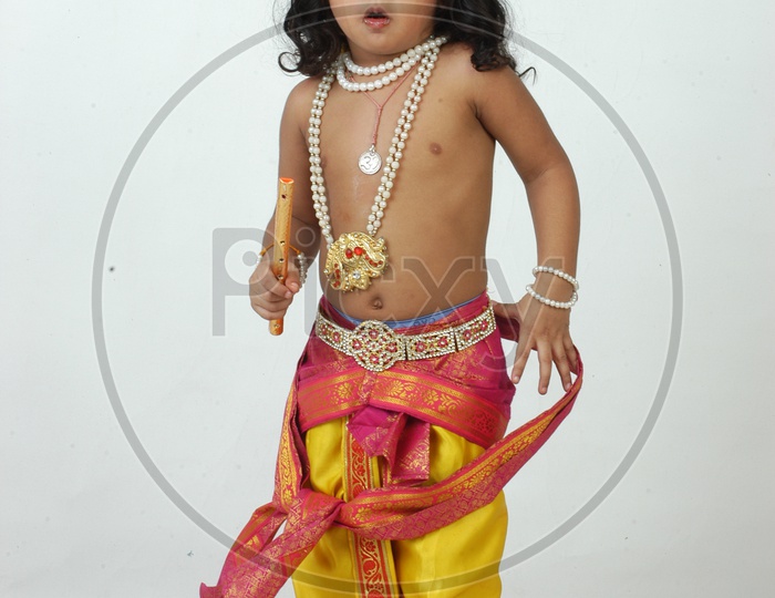 Indian Boy in Lord Sri Krishna Getup  Over an isolated White Background