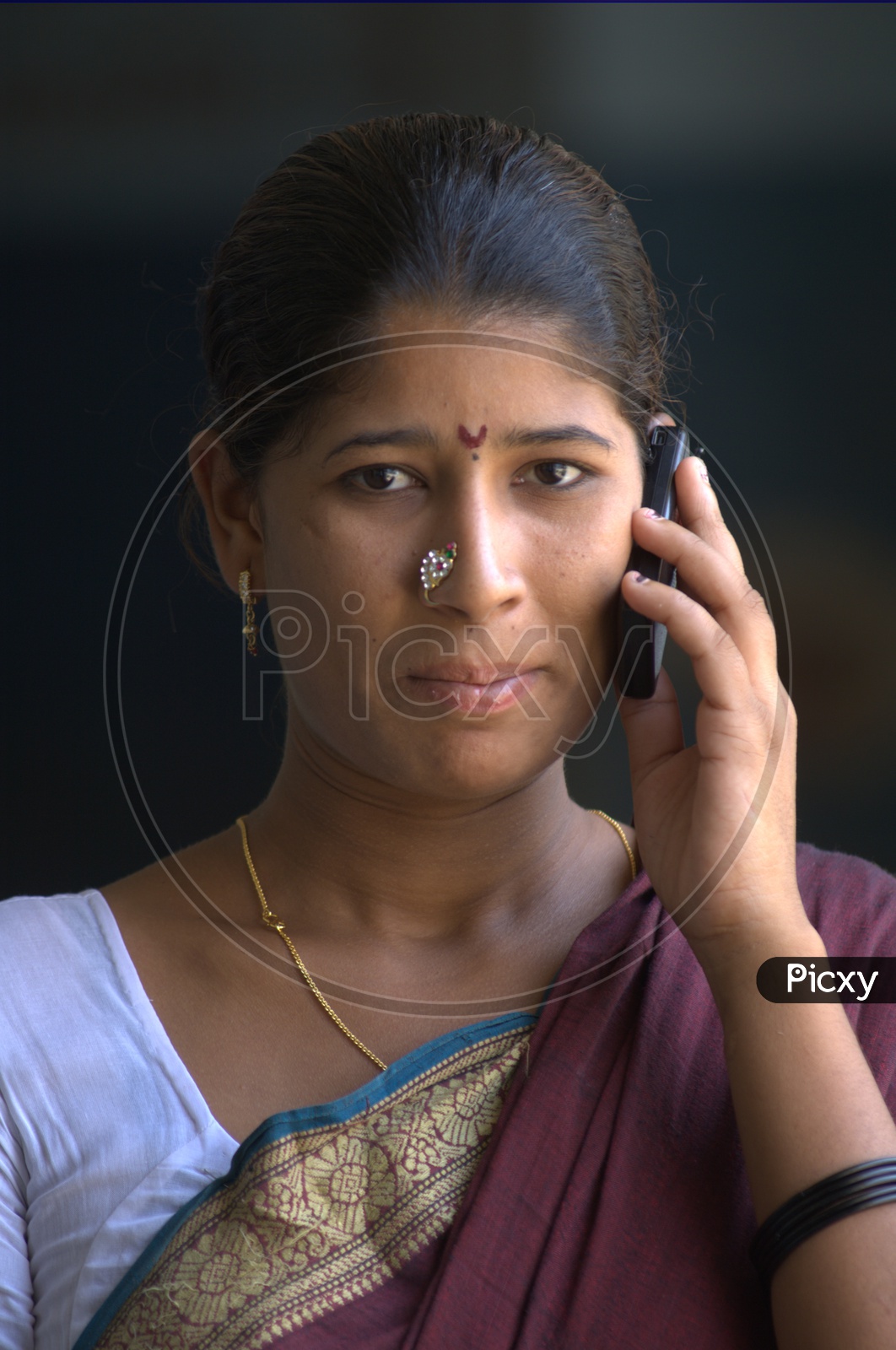 Indian Rural Woman speaking  in Mobile Phone