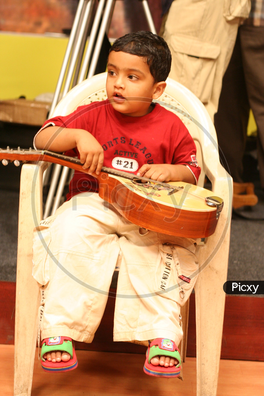 Indian Kid in a studio with a musical instrument