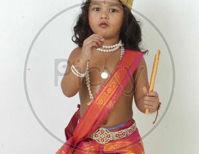 Indian Boy in Lord Sri Krishna Getup   Over an isolated White Background