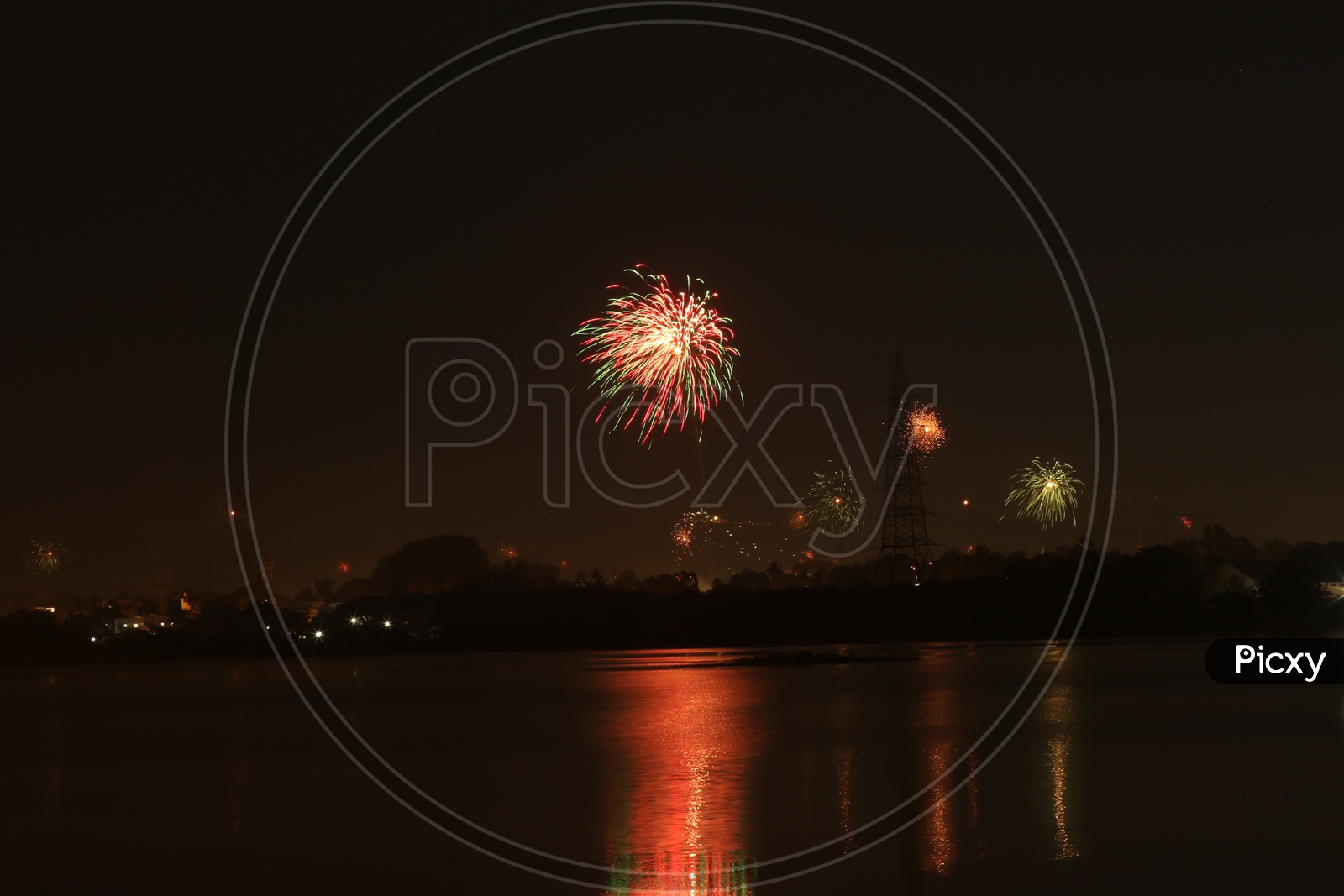 A Beautiful Long Exposure Shot Of a Diwali Crackers over a City View and Reflection on Water