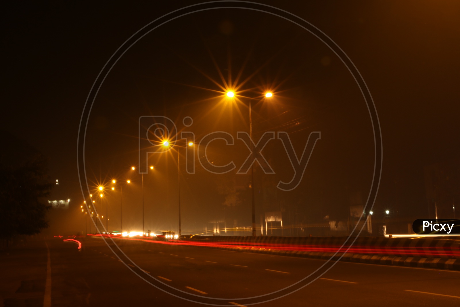 A Beautiful Long Exposure Shot Of a Highway Road With Lights In The Night Time and Vehicles Moving on the Road