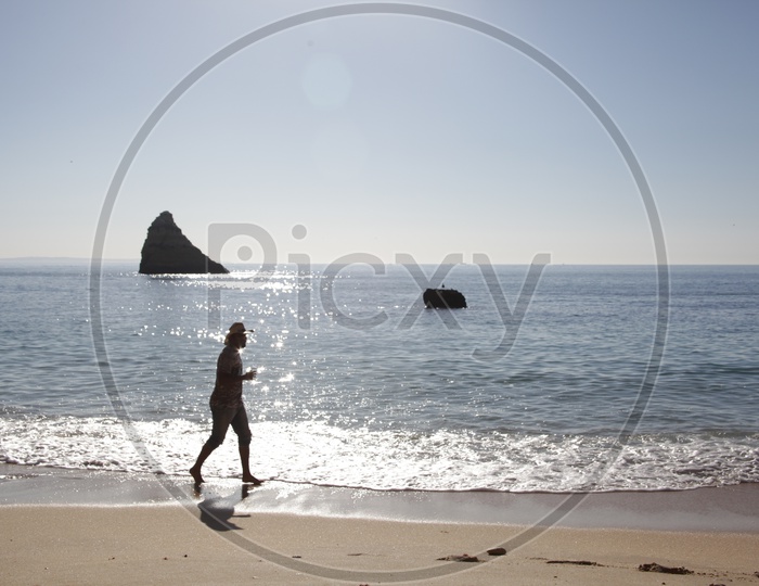 silhouette of a man Running in A Beach