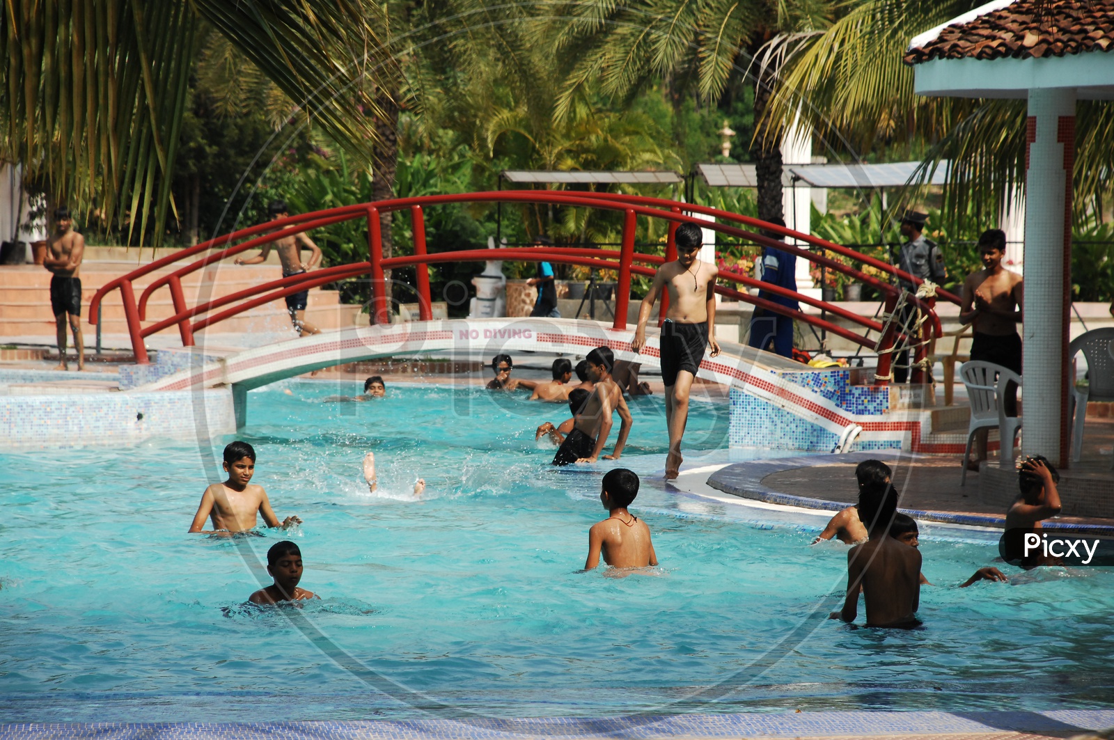 Children and men Playing in the swimming pool at a Water park