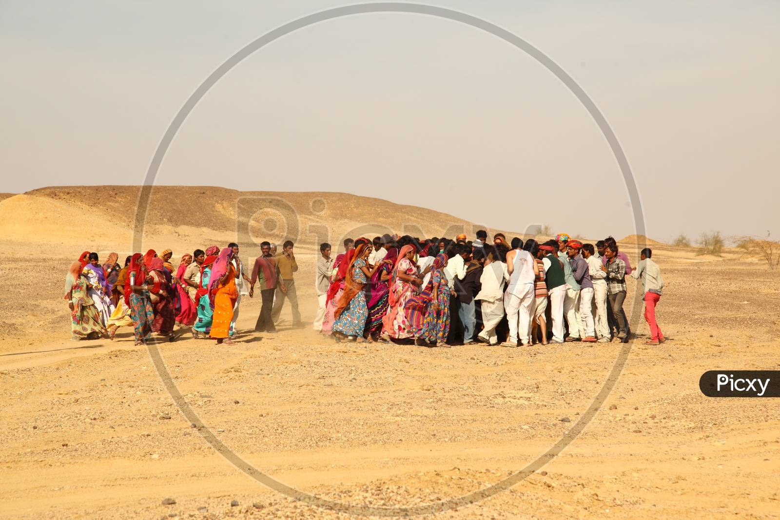 Village People in Rajasthan Running In Desert in order