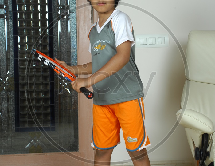 Indian Kid with Tennis bat
