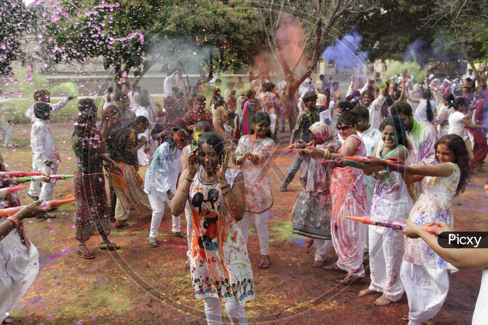People celebrating holi festival / People throwing colors to each other during the Holi celebration in Hyderabad/ Indian Festival