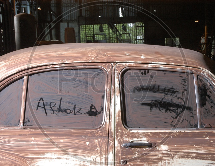 An Old Dusted Ambassidor Car Closeup Shot  in a garage