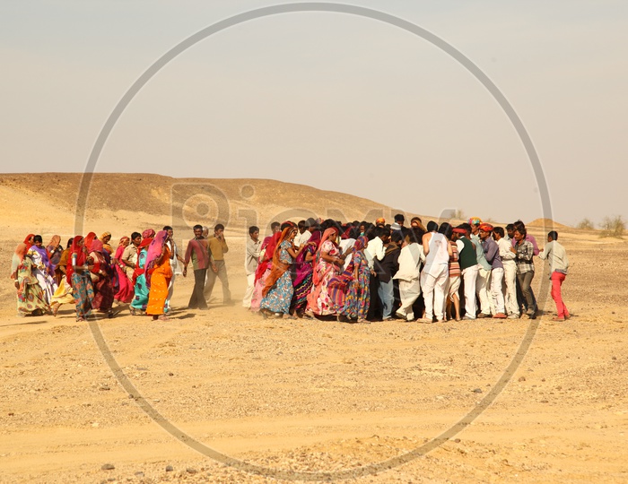 Village People in Rajasthan Running In Desert in order