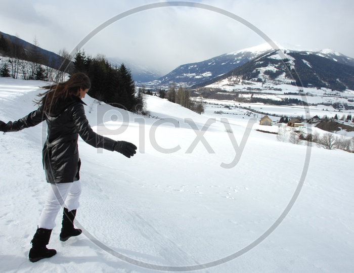 An Indian Girl Enjoying in  Snow Capped Mountains