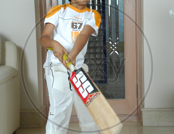 Indian Kid with cricket bat
